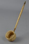 AN EARLY 19TH CENTURY BONE TODDY LADLE, cauldron shaped bowl on a turned handle, length