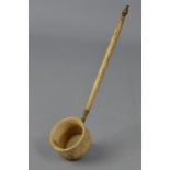 AN EARLY 19TH CENTURY BONE TODDY LADLE, cauldron shaped bowl on a turned handle, length