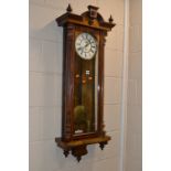 A VICTORIAN VIENNA WALNUT WALL CLOCK, the circular enamel dial with Roman numerals and subsidiary