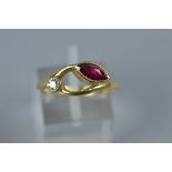 A MODERN 18CT GOLD RUBY AND DIAMOND ABSTRACT TWO STONE RING, one marquise cut ruby measuring