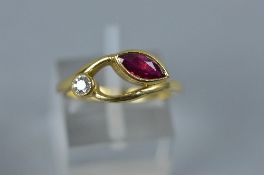 A MODERN 18CT GOLD RUBY AND DIAMOND ABSTRACT TWO STONE RING, one marquise cut ruby measuring