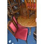 A PINE CIRCULAR KITCHEN TABLE, and eight various oak chairs (9)