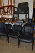 A SET OF SIX LEATHERETTE UPHOLSTERED CONFERENCE CHAIRS