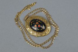 A LATE 20TH CENTURY 9CT GOLD OVAL LOCKET WITH A ENAMELLED FLORAL FRONT, enclosed within a scroll