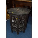 A CARVED OAK FOLDING OCCASIONAL TABLE, with pierced leaf and fruit design