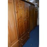 A PINE TWO DOOR WARDROBE, above two long drawers