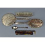 A FOUR PIECE SILVER BRUSH SET, and a teaspoon