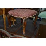A VICTORIAN MAHOGANY FOOTSTOOL, with overstuffed upholstery, on scrolled legs