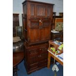 AN OLD CHARM OAK FALL FRONT DRINKS CABINET, above a double cupboard door, approximate size width