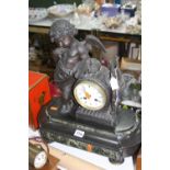 A LATE 19TH CENTURY MANTEL CLOCK, the case cast with a cherub with artist's palette and brushes,