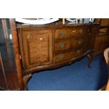 A WALNUT SERPENTINE SIDEBOARD, with three drawers central to two cupboard doors on cabriole legs,