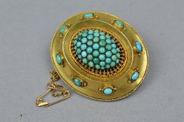 A MID VICTORIAN TURQUOISE BROOCH, an oval shape centering on a domed cluster of round cabochon cut
