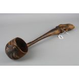 A CARVED TREEN LADLE, with Kiwi bird finial, the ladle bowl exterior carved as a head, length