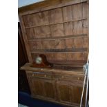 A VICTORIAN PINE KITCHEN DRESSER, with three tier open shelving above two drawers and double