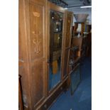 AN ART NOUVEAU OAK TWO PIECE BEDROOM SUITE, comprising of a single mirror door wardrobe (no