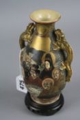 A JAPANESE SATSUMA WARE TWIN HANDLED VASE, decorated with figures of immortals amongst raised