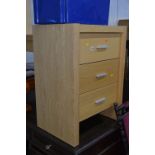 A LIGHT OAK FINISH CHEST, of three drawers, approximate size width 63cm x height 85cm x depth 45cm