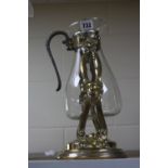 A VICTORIAN STYLE GLASS AND SILVER PLATED ON BRASS CARAFE ON STAND, height 35.5cm, lacks burner