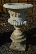 A COMPOSITE GARDEN URN ON STONE STAND, total height approximately 97cm