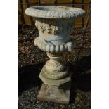 A COMPOSITE GARDEN URN ON STONE STAND, total height approximately 97cm