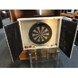 A PAINTED TWO DOOR DARTS BOARD