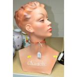 A PAINTED PLASTER FEMALE BUST, moulded with Chantelle to her upper chest