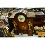 AN EDWARDIAN MAHOGANY AND INLAID MANTLE CLOCK, with domed top, enamelled dial above two gilt metal