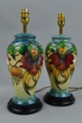 A PAIR OF MOORCROFT ANNA LILY TABLE LAMPS, of baluster form, designed by Nicola Slaney, both mounted