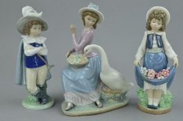 A LLADRO FIGURE GROUP, No 5034, 'Goose trying to Eat', together with two Nao figures, young Cavalier