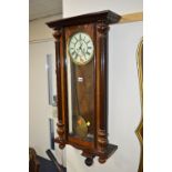 A VICTORIAN WALNUT VIENNA WALL CLOCK, 8 day movement, circular enamel dial with Roman numerals,