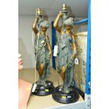 A PAIR OF PAINTED SPELTER FIGURAL TABLE LAMPS, each of a classical lady on a black glazed ceramic