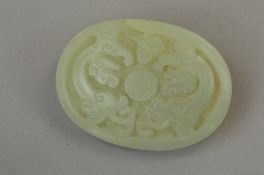 A PALE JADE OVAL PAPERWEIGHT CARVED WITH MYTHICAL CREATURE