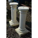 A PAIR OF COMPOSITE COLUMNS, standing 68cm high (2)