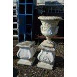 A COMPOSITE GARDEN URN, and two square columns, urns stands 49cm high