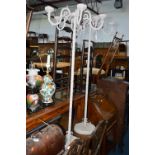 A PAIR OF PAINTED METAL FIVE BRANCH CANDLE STANDS