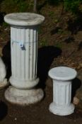 TWO COMPOSITE GARDEN COLUMNS, one 80cm high, the other 38cm high (approximately)