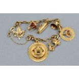 A 9CT CHARM BRACELET WITH SEVEN CHARMS, approximate size 16.5 grams