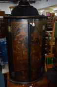 AN ORIENTAL BLACK LACQUERED BOW FRONT HANGING CORNER CUPBOARD, the doors with Japan scenes (sd)