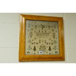 AN EARLY 19TH CENTURY NEEDLEWORK SAMPLER, central verse surrounded by birds, flowers and trees