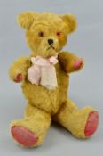 A GOLDEN PLUSH TEDDY BEAR, vertical stitched nose, plastic eyes, jointed body with original (worn)