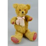 A GOLDEN PLUSH TEDDY BEAR, vertical stitched nose, plastic eyes, jointed body with original (worn)