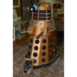 A FULL SIZE REPLICA DALEK, of fibre glass and plastic construction and mounted on a wheeled metal