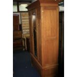 AN EDWARDIAN SATINWOOD SINGLE MIRROR DOOR WARDROBE above a single drawer