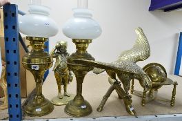 A PAIR OF BRASS BASE OIL LAMPS, a brass sculpture of an Eagle, brass sculpture of Mr Pickwick and