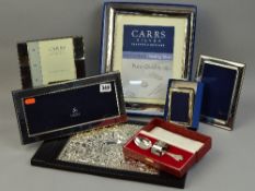 A SELECTION OF FIVE SILVER PHOTO FRAMES, silver blotter, napkin and spoon