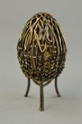 A SILVER ST JAMES HOUSE NOVELTY EGG ON STAND