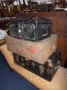 A VINTAGE TRAVELLING TRUNK, hide covered suitcase and a metal ammo crate (3)