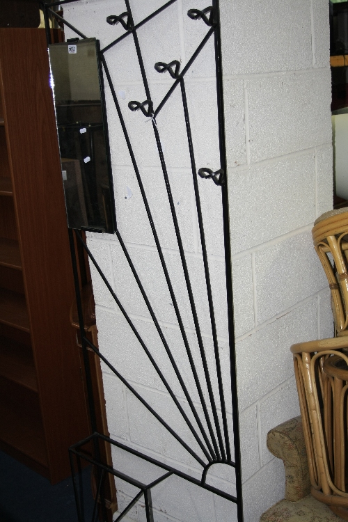 A METAL HALL STAND, with sunburst pattern to front and a mirror