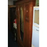 AN OAK MIRRORED SINGLE DOOR WARDROBE, and an oak dressing table with oval mirror (in isle opposite)