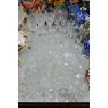 A QUANTITY OF CUT GLASS DRINKING GLASSES ETC, to include wine glasses, sherry glasses, vases and